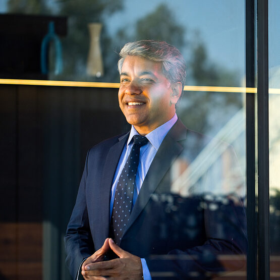 A wealthy, affluent investor smiles.