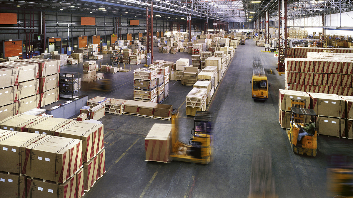 View from above inside a busy huge industrial warehouse