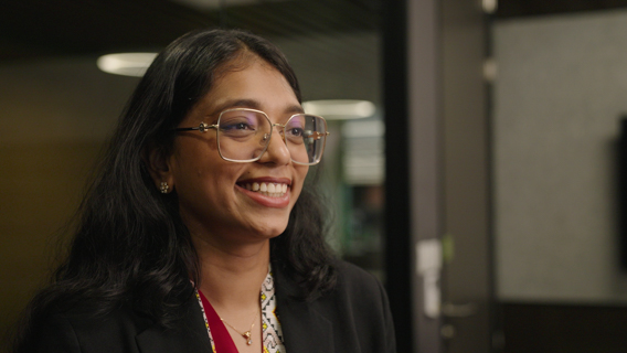 A lady with glasses smiling